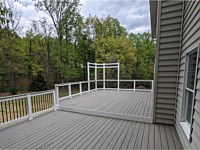 <b>Trex composite decking with white vinyl railing and black alumimum balusters and drink rail and a perimeter trellis</b>